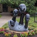 Springstone sculpture titled Four Generations by Joe Mutasa in the Fort Worth Botanic Garden.