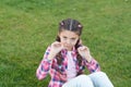 Springtime concept. Park and garden. Kid gadabout. Girl little kid spend leisure outdoors in park. Girl sit on grass in Royalty Free Stock Photo