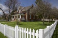 Springtime in the front lawn of the house with white picket fences Royalty Free Stock Photo