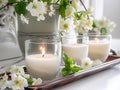 Springtime home decor, spring interior decorations with flowers and burning candles, bright white apartment in daylight