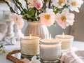 Springtime home decor, spring interior decorations with flowers and burning candles, bright white apartment in daylight