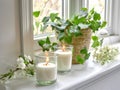 Springtime home decor, spring interior decorations with flowers and burning candles, bright white apartment in daylight