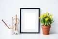 Springtime home decor with yellow daffodil flowers and frame mock-up
