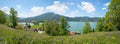 Springtime panorama, beautiful flower meadow and view to lake Tegernsee, Leeberg hill, bavarian alps Royalty Free Stock Photo