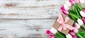 Springtime pink tulips on white rustic wooden boards