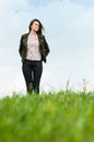 Springtime relaxation with young girl sitting on green field Royalty Free Stock Photo