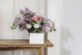 Springtime still life. Blank horizontal greeting card, invitation. Vase with bouquet of lilac, viburnum and tulips on Royalty Free Stock Photo