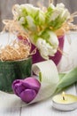 Springtime table decoration with tulips and lit candle