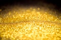 Sprinkle glitter gold dust on a black background Royalty Free Stock Photo