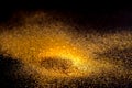 Sprinkle glitter gold dust on a black background Royalty Free Stock Photo