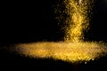 Sprinkle gold dust on a black background