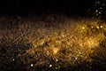 Sprinkle gold dust on a black background