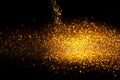 Sprinkle gold glitter dust on a black background