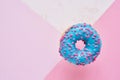 Sprinkled Blue Donut. Glazed sprinkled donut on colorful pink background. Top view, copy space Royalty Free Stock Photo