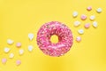 Sprinkled Pink Donut. Glazed sprinkled donut on yellow background. Top view, copy space Royalty Free Stock Photo