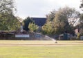 Sprinkler in action water spray on cricket green field