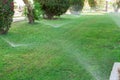 Sprinkler in garden watering the lawn. Automatic watering lawns concept Royalty Free Stock Photo