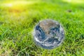 Green grass field with blue world wide planet earth. elements of this image furnished by NASA Royalty Free Stock Photo