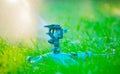 Sprinkler head watering green grass lawn. Gardening concept. Smart garden activated with full automatic sprinkler irrigation syste Royalty Free Stock Photo