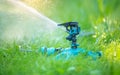 Sprinkler head watering green grass lawn. Gardening concept. Smart garden activated with full automatic sprinkler irrigation syste Royalty Free Stock Photo