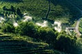 Sprinkler irrigation in an orchard - Trentino Alto Adige Italy Royalty Free Stock Photo