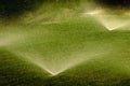 Sprinkler Spraying Water on Lush Green Lawn Yard Royalty Free Stock Photo