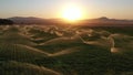 Sprinkler system in a grass field. Slow motion view. Aerial vire..