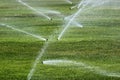 Sprinklers on a green lawn Royalty Free Stock Photo