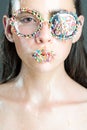 Sprinkles lipstick and glasses on girl, valentines day. Young woman with sprinkles makeup. Beauty and fashion model of