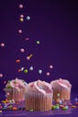 Sprinkles raining down on a pink mini cupcake Royalty Free Stock Photo