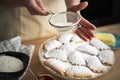 Close up of sprinkling and decorating cookies with powdered sugar Royalty Free Stock Photo