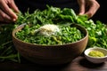 sprinkling freshly chopped coriander leaves over a falafel bowl Royalty Free Stock Photo
