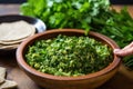 sprinkling freshly chopped coriander leaves over a falafel bowl Royalty Free Stock Photo