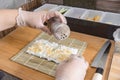 Sprinkling Furikake on top of a layer short grain rice on a Makisu. Making sushi rolls Royalty Free Stock Photo