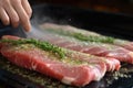 sprinkling herbs on raw pork loin for marination Royalty Free Stock Photo