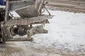 Sprinkling salt on a sidewalk after snowfall