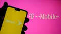 Sprint and T mobile logos on the screens of mobile devices. Concept for merger of two companies. Real photo, no edit in post