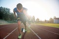 Sprinter leaving starting blocks on the running track. Explosive start. Royalty Free Stock Photo