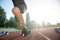 Sprinter leaving starting blocks on the running track. Explosive start. Royalty Free Stock Photo