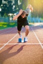 Sprinter leaving starting blocks on the running track. Explosive start.