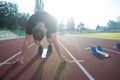 Sprinter leaving starting blocks on the running track. Explosive start. Royalty Free Stock Photo