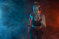 Sprinter run. Strong athletic woman running on black background wearing in the sportswear. Fitness and sport motivation Royalty Free Stock Photo