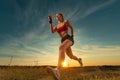 Sprinter run. Strong athletic woman running on black background wearing in the sportswear. Fitness and sport motivation Royalty Free Stock Photo