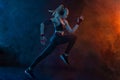 Sprinter run. Strong athletic woman running on black background wearing in the sportswear. Fitness and sport motivation Royalty Free Stock Photo