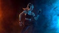 Sprinter run. Strong athletic woman running on black background wearing in the sportswear. Fitness and sport motivation Royalty Free Stock Photo