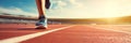 Sprinter waiting for start of race on running tracks at outdoor stadium. Sport and fitness runner man athlete on blue run track Royalty Free Stock Photo