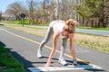 Sprinter woman getting ready to start on the running track