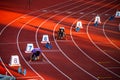 Sprinters Ready to Begin the 200m Race, Captured at the Precise Moment of Starting Blocks Setup - Track and Field Illustration