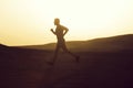 Man runner running in dune at sunset Royalty Free Stock Photo