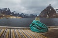 Spriral natical rope at a wooden pier on the background of mountains and landscapes on the islands Lofoten. Place for text or Royalty Free Stock Photo